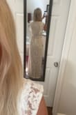 I was a little nervous about ordering this one online, but it did not disappoint! The dress is lined with a thicker nude-colored underlining and the lace on the outside is a softer lace material, so it is not stiff. I think it would fit perfectly (me personally) with a little tailoring around the waist. Because of my height and shoulders, a medium is perfect otherwise. Loved the combination of modesty and sexiness with this dress! Would pair nicely with a diamond or pearl sash- but is not necessary because it is beautiful as is! - Candace C.