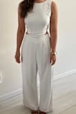 This white jumpsuit is great! I'm 5'4", 127ish pounds, usually a medium (8 or 10), and I ordered the medium. I was debating the small but glad I went with the medium even though I did need to get it hemmed in the length and taken in a little in the waist and bodice (see before/after photos). I felt very chic and received compliments on it. I can't wait to wear it again, I love it! - Meera N.