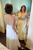 Such a simple, elegant and beautiful dress! I fell in love with this dress the moment I saw it! The fabric is very good quality and those beads are absolutely amazing. I was lucky to have perfect sunny weather on my wedding day and those beads were glowing the entire time. The dress runs a little bit small, or maybe it's just my body shape, but I had to get a size 6 when normally I wear size 2 on all dresses. The dress needed tailoring since I am petite and I had to cut almost 5" from the length of it. Based on another review for this dress I ended up adding a white fabric underneath the part where it is transparent. The opening in the back was a bit loose, but I taped it to my skin using double-sided fabric tape and it looked perfect. I would recommend this dress to anyone. It's almost wrinkle-free, so light and comfortable. - Liliana I.