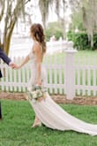 This dress is so simple, but perfect! The low back, front slit, and long train give it that wow factor. I love telling everyone I got my wedding dress for $100 too. - Brittany B.
