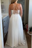 I ordered this dress along with several others for an at-home try-on party with my closest friends & family. We had a charcuterie board, wine, & SO MUCH FUN! Way better than a 60-minute appointment with a limited # of guests - typical of a bridal boutique! I will say that my expectations for online wedding dresses at this price point were fairly low. However, with Lulus' generous return policy I had nothing to lose. Wow!! I'm so glad I took a chance! I was so surprised at the quality! I didn't tell anyone the prices until after I tried on every dress. NO ONE could believe it. These dresses could easily hang in a bridal boutique & you would never know the difference. Seriously! This particular dress fit great & the bottom flowed well. The lace-up back would allow for various bust sizes but the waistband doesn't have any give so base size off that. The length would have been the only alteration needed. I returned it only because I fell in love with another Lulus dress. I can't wait to wear it for my wedding! - Kristi W.