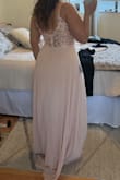 The dress is a beautiful color like the photo. No stretch to the fabric and a zippered back. Love the button detail and lace. Not too heavy of fabric and not see-through. Didn't need a bra. A little long without shoes. - Camille L.