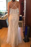 This dress fits true to size and has a lot of beautiful detail. The dress is well made, but a bit heavy (I think my shoulders would have felt it by the end of the night). This would be a very unique wedding dress, and if the shoulders were a bit more comfortable I would have definitely worn this on the big day. - Caroline D.