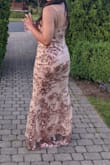 This is a very stretchy dress. I had a large dinner and drinks, and it moved with me! It even lasted through a twerk test. The fit was never uncomfortable, and it looked great! The sequins were a bit itchy, but I stopped noticing fairly quickly. 

I was not wearing a bra and felt supported. There is no padding, but you can easily sew some on. I do have itty bitties though, so that helps.

I'm wearing four inch heels and the mesh overlay of the dress hit the floor with a little surplus. The lining was a couple inches off the ground so it made it easier to walk. - Anna G.