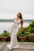 I wore this for my reception dress. Absolutely loved it! I had my tailor add bra cups to it, which made everything super easy. A little hard to get on and off, as there is no zipper or buttons. - Courtney G.