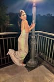 I wore this beauty to a wedding and I received so many compliments. The dress has a high slit but is totally manageable. Felt sexy and glamorous throughout the entire night. If you're debating whether you should buy, do it! You will not regret it! - Ashey O.
