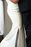 I honestly didn't think this dress would be my #1 for my wedding dress but I put it on and I loved it!! I was dancing around the house in it and it is very flattering. I would definitely say size up in this dress! I have more of an athletic build and I usually wear a size medium top, size 10 Jean, but I ended up ordering a size XL in this dress (because the L was out of stock) and it fit me the absolute best!! I am 5'2 and had to get it hemmed, but I also added a slit in it when I got it hemmed. - Bailey F.