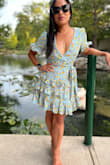 I really wish Lulus would come out with petite sizing! I love this dress but there are some components that could be improved if there were petite sizing options. That being said, the dress has little to no stretch and was a little tight on my back and in the arms. The hem falls lower on my frame (slightly above the knees) than it does on the model but this was to be expected since I am 4'11". I got a ton of compliments on this dress on my social media accounts. - Desiree B.