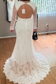 Dress has beautiful lace and is very light fabric weight so it does not feel heavy at all. Easy to put on by myself and comfortable to move in! The dress is not tight around the hips or thigh area. Perfect dress to wear for my January elopement in cold weather! - Renee G.