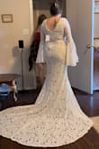 I said yes to the dress and can't wait to wear this in my October 2023 wedding. I wanted to find a perfect bell sleeve lace dress for my boho wedding, but was having a hard time finding one for a decent price! Most of them were $2,000 and up! This is the perfect dress for only $149!!! It's a steal! It is perfect and hugs my body perfectly! It is so comfortable and feels sturdy. The lace is not dainty, so I won't be nervous about the lace all night. Love the trim around the V on the chest. The sleeves are so dreamy and the train is perfect! This is everything I could have ever dreamed about in a budget wedding dress. I love almost everything about this dress. There are almost always some kind of alteration to be made, but I only want to change one small detail. The slip hangs out past the dress slit in the front, so I want to get that sewn together. I may also have a bussell made into the back to keep the train from dragging all night. I'm so happy with my purchase and glad I decided to buy from Lulus! - Kaetlyn M.