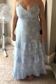 The dress itself is very pretty and fits well! I am not sure if I will keep it though. The hem is not straight and pretty noticeable (you can visibly see my foot in the image on one side more than the other). Might return this one and order another to see if the uneven hem is normal or just this particular dress. - Lindsey B.