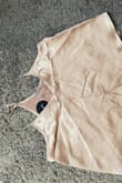 I had my eye on this for a while. I had it saved in my wish list waiting for it to go on sale because who doesn't love a sale! I finally ordered and received and I'm so disappointed with the quality. This isn't the usual Lulus quality that I've come to love and expect. I was so excited about my champagne-colored pajamas and it honestly looks like gold foil. The material is scratchy on the interior side. The stitching isn't good either as you can see in the pictures - notice the stitch line at the hem of the ruffle on the shorts. The fit is spot on for my body but I will be returning. Possibly the material looks better in one of the other colors. Good luck shopping babes! - Chelsea A.