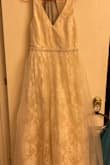 This dress is gorgeous and I can't believe I got it for this price. I have to have it shortened a bit, but everything else fits great. I've got a bit of extra fluff in my middle, so that's part of the tightness. Top is very fitted and flattering on the chest for the size I am. Don't have a picture of the finished product yet, ad I am getting married in 2 months. - Sierra D.