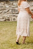I picked this dress for a garden photoshoot & I loved it. The medium hugged me a little bit in the abdomen/torso area but I probably could have worn Spanx to smooth it out a bit. Very comfortable and airy. Good summer dress for a nicer occasion. - Ashley K.