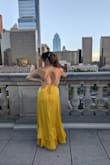 I absolutely LOVED this dress! It is simple and elegant and truly shines through its beautiful marigold color and it is flowy design. The only reason I give it 4 stars instead of 5 is because the bust seam didn't lay flat and kept turning out.

I love that it's low cut (get ready to wear sticky cups or no bra) and despite it being a bit bigger in the bust than I would expect, the true issue is that the bust part kept flipping over and showing the underside of the dress. I managed to fix this by using A LOT of fashion tape, but that only worked up to a certain point. If you look closely at other customer photos, you can see that the bust seam is turned over in many of them. If that was fixed, it would truly be the perfect dress. Regardless, I loved wearing it and felt a bit like a modern-day Belle from Beauty and the Beast. - Elizabeth E.
