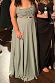 I was worried the XL would be too long but with heels it was perfect, and even barefoot it wasn't dragging too badly. I was also surprised by how flattering it was! I typically wear at size 14 & wore some shapewear under this dress which helped. I wish it was made in a 1X or XXL because the XL juuuust fit like a glove & I'm a fan of some wiggle room!! Material is not stretchy. All in all, I received many compliments and felt great in this dress!! - Sophia T.