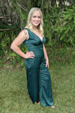 I am 5'7", 160ish lbs, athletic. This jumpsuit is not meant for those with a long torso. I would say I have a regular-length torso but did feel as if it rode up a bit in the front area. Also, I know I have a wider rib cage than many, so there was a challenge zipping up, and it was right around my ribs. 
A little darker emerald green than what I expected in online photos.
Otherwise, it was a fun piece to wear and I might wear it again someday! - Leah M.
