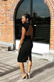 This dress fits like a glove. The dress comes up high enough in the back to wear shape wear. I wore it for summer wedding. The thick material is better for fall or spring. - Coco T.