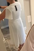 I love this dress! I love that it ties closed making it extremely versatile to your size and body shape. I eloped and was going to wear this as my #1 choice. But the issue I ran into was with the bust - if you have a larger bust and can fill out the top - the better. Going no bra you could see through it completely. Even with pasties on you could see the outline of my pasties. Every bra I put on it was so low cut you could see my bra at the bottom between the boobs. So then I tried some body suits but they all showed through and didn't match the exact white color. I feel body suits are a must or spanx or some kind though because the back (and butt) were very very see through as well. Wearing something under this like a cami or body suit to help cover up bust for someone with a smaller bust would be the way to go I think. Maybe if I had gotten it in another color other than white I would go braless. Didn't end up wearing it but still kept it for another time. - Katie A.