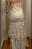 Its a gorgeous dress, but itt had a lot of misteps. The zipper is awful, it gets stuck every time. Its a size small but barely hugs my hips at all. The front is not flattering and gives me a "baby bump" which I dont have, nor would not want for a wedding. Im not that shapely of a person but it gives me huge hips - Hana P.