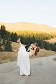 My husband proposed to me on 24th, 2020 while we hiked in the mountains of Breckenridge, CO. We decided our wedding would be exactly one year later; September 24th, 2021. A week before our wedding, COVID threw us a curve ball. We chose to post-pone our original plans and took a vacation instead. We rented a camper van in Denver and began the best road trip of our lives. I left my original wedding dress back home and ordered this dress from Lulus. I had it shipped to a friends house in Colorado. If it fit perfectly, we decided wed elope, if not, wed wait until next year to get married at our postponed wedding. 
Well the dress fit PERFECTLY! I paired it with my hiking boots and we returned to the same mountain trail where I originally said "YES!" to exchange our vows. The day was absolutely beautiful, filled with nothing but laughter and happy tears.  And the photos are truly stunning! - Hayley R.