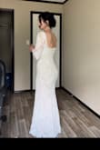This dress is stunning. Ordered both small and xsmall. I'm 140lbs and the xsmall fit perfect. The slit is high like everyone else's review but it didn't bother me at all. It a bit thinner than some of the other Lulus long sleeve wedding dresses I ordered. It's so pretty! I did however go with a different dress from this site! I've tried 4 dress styles and they are all so pretty! - Jenna R.