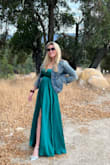I had been eyeballing this dress for years and it would always sell out right as I was ready to take the plunge to buy it for a special occasion. 
It came back in stock just as I was shopping for a Vineyard wedding and it fit exactly what I had in mind! Love it. It is a satiny dress so any water or liquid you might accidentally spill sticks around for a while lol so don't mind the water spot on my chest. The slit also runs up high so just gotta be mindful when twirling it posing for pics - Amaris J.