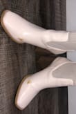 I love the look of these boots but unfortunately, after wearing them only for one night to a restaurant my feet rubbed against each other and the paint was quickly removed from the outside of the shoe revealing a tan undertone. - Carley S.