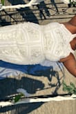 Wore it for my beach wedding and I loved it. It was a bit long but when paired with wedges it was the perfect length. Fit true to size. I have a large bust area which is usually a problem but it was perfect. More ivory with white trimming. - Gabriela B.