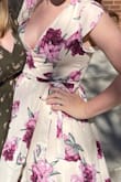 The colors of this dress are gorgeous and I was so happy with it looks in person. This dress definitely shows a lot of cleavage. I probably should have sized up to the large, but I think I would have been swimming in it up top. I used a safety pin to try not to fall out of the dress, but I love the dress enough I'll probably get it tailored to fit me properly. It's a very fun dress and I got lots of compliments. - Rachel L.