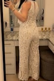 Its a bit larger then it should be. Id say go a size down! It is stunning and i felt like a glass of champagne wearing it. It gets a bit looser as you wear it as well so a XS would have been best for my body only for this particular jumpsuit! Received a lot of compliments on my outfit so it was a hit in my books even if it was a bit large on me. - Sophie M.