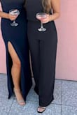 Loved this purchase. The high neck, attached via three, small fabric buttons, not too tight at all either, and wide leg cut on this jumpsuit is so flattering (brushes the tops of my thighs and hugs my butt). The open back elevates the whole look! I wore this with 2.5 inch heels and the hem just brushed the floor. Tip: there's an elastic at the waist, the higher you pull this up your torso, the less it needs to be hemmed and the more the look is flattering. Needed a quick steam coming out of the packaging. I got so many compliments on it, and it's a staple piece in my wardrobe for more formal events now! - Rachel C.