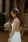 Instead of going to a bridal boutique, I ordered several Lulu's wedding dresses and my bridesmaids created our own "at-home" boutique for me to try them on. It was such a good time! I ended up keeping 3 of the dresses -- one for my rehearsal dinner, one for my ceremony, and one for my reception. This was my ceremony dress and it fit perfectly. No alterations were done besides 2 small stitches at the top to hold the lace down to the shoulder straps. Would have no idea it wasn't $5000! I paired it with a plain cathedral veil and about 3 inch heels. - Madison B.