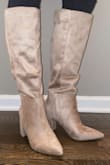 I LOVE these boots! I've been looking for boots just like these for a year and can't find any less than $300! I was hesitant to order these just because the photos make them look slouchy, but I'm so glad I read one review stating they're not! Attaching photos to show y'all too! These are perfect and look like great quality, designer boots! - Lauralane P.