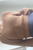 The top is open knit/stitch so it is see through. However, if you can find the right bra, it's really cute and fits true to size. Flattering on athletic builds. - Penny M.