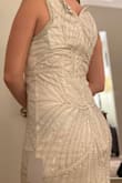 I loved this dress as soon as I put it on! It fits like a dream. It is fun, flirty, and elegant at the same time. The beading was absolutely beautiful, but made the dress appear less white. It appears more silver in person. This is a great find! - Janine R.