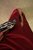 This dress was stunning from the color to the material and the way it flows from hte slit when you walk, without fear of it showing too much. I wore it to a work event and foolishly did not take any pics of me all dolled up in it but it looked and felt great. I wore a strapless bra and had no issues with it slipping. The length is great for those of us with long legs, maybe too long but with heels it fell perfectly. Be careful with your jewelry though as my necklace snagged it at the top and I can't fix it now :(  It fit a little loose at the waist but that made sitting more comfortable than if I got the XS, which probably would've felt too stiff. Overall very happy with my purchase and received many compliments throughout the night. - Allison D.