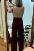 The fit is flattering. I bought both a medium and a small and the medium was definitely too big. The small fit perfect. I didn't notice this but it has pockets! My butt looked great. I felt like the crotch was a little low from the front but only I noticed- I got a ton of compliments. Wore with 4 inch heels and the length was good, looks like the length on the model. The straps are a little weird and I thought would fall but honestly I had no issues. I wore it to a holiday party and plan to wear it again to a black tie wedding ceremony with a blazer. - Raleigh T.