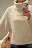 I confused myself with this sweater because I tried it on with sweatpants and hated it. Everything is big and it made me feel big. Except the turtleneck part which is amazing. So I went back to my order to see what convinced me to order this, and it looked so cute on everyone. So I threw on some skinny jeans and voila! I loved it. So, it's definitely a big poofy sweater. Balance it with a mini skirt or skinny jeans! The turtleneck part is the best I've found all season. Photos cropped strangely upon uploading, but tried to give the gist of it. - Crystal W.