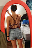 This bodysuit is VERY thin. The straps in the back are cute, but unfortunately, they are not adjustable, and it did not fit me perfectly. The fabric bunched around my chest on the side, so I ended up returning. Would probably have fit better on someone with a larger chest. - Kelsey L.