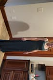 Dress is very form-fitting and flattering. The material is substantial and not flimsy. Dress is lined and has a covered zipper. The slit is thigh high fyi. Overall pleased with purchase! - Dana P.