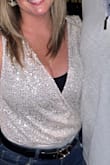 I got lots of compliments on this top at my event! BUT it really annoyed me how the mesh on the body suit kept creeping up above the waist line on my jeans. According to other reviews the top runs large, so I got a size medium. The top part with sequins fit well enough (although definitely required an undershirt, lots of chest exposed!) But the bodysuit portion had an odd fit. It didn't have a lot of stretch or give, so it kept riding up. Unfortunately I didn't have any high rise jeans to wear to my event so I ended up with lots of pictures like these... which I'm sure no one noticed but me, but still - Jennifer C.