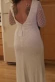 This dress was exactly what I had hoped for when looking for winter dresses for a last-minute elopement. I got a size medium because my lower half is curvy. The dress fit perfectly, the only issue was since I don't have a large bust the sleeves would slide off from time to time. Since my hair was down, I ended up tying the hanging threads that it came with together, which worked for me. The slit is very sexy but high, so if you are not comfortable showing some leg, I would keep that in mind. This dress is simple but elegant! I felt beautiful in it and received way more compliments than I was ready for. - Niki A.