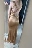 This dress is nice material and flattering, however its more of a bronze, darker shade of gold than the light gold on the model. Im wearing an XS. - Amy J.