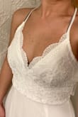 This dress fit absolutely perfect. After reading previous reviews, I went with the XS. The dress fit perfectly, not too tight but just right. Snug enough to feel secure. I love this dress and cannot wait for wear it for my wedding. - Candice C.