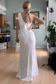 I like this dress for my courthouse wedding. It's simple, and modest. The shoulder detail is very cute. The pictures are fresh out of the package, it looks a lot better when steamed but I forgot to take a picture of that. With this type of fabric, you either want to wear shape-wear underneath or be aware that everything shows, as you can tell from the pictures. It works fine without a bra for me but some pasties will be good as it's cold here.
The length is good, I'm just in socks in the pictures, so a few inch heels will serve the purpose.
I am keeping this, but you definitely need to be aware that this is not a high-quality dress. You get what you paid for. - Kim S.