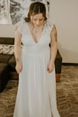 I bought two sizes of this dress because I wasn't sure if a size L would fit me, so I also got a size XL and it fitted just perfect! 
This dress runs a little small so if you're a strong/chubby bride like me, size it up like I did.

The fabric and the lace on the dress is so pretty and delicate. It look very good on my body, I felt like a princess with this dress! - Stephanie G.
