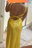 Bought the dress with Andie Anderson from How to Lose a Guy in 10 Days in mind. Material is giving Belle from Beauty and the Beast. Definitely more shiny/glossy than expected. More accurate picture is the dress from the front. It truly is a vibrant color. Debating on whether or not to return it because I do like the fit despite needing some alterations. Future alterations to the dress include: hem (it has a sort of train on the back, which I'm not complaining about because I would rather have the dress too long than too short so I can find the right shoes) and the straps (I always find I need to alter the straps of dresses to prevent myself from falling out of the bust). The cut of the front is very flattering and works easily with sticky boobs. I love the back, but you can tell the straps are too long in that picture. Material wrinkles easily. - Audrey B.