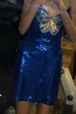 I originally found this dress when I was looking for a blue butterfly dress to match my new blue butterfly cowgirl boots to wear to an upcoming concert. When I saw this dress I knew it was literally meant to be because of how perfect it is so of course I bought it. The all-over sequins are gorgeous and I LOVE the butterfly in the middle. The back is also beautiful I love the cross tie back since the original measurements are a bit loose for me but I can adjust and make it more fitted with the ties. The front does go a little low, not to where I'm scared I'm gonna flash someone but it definitely is a cleavage dress, so do know that if you get worried about that kind of stuff. I literally love this dress so much though and will definitely be getting more use out of it besides the concert-like dances and parties!!! - Kylie G.