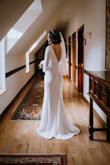 I wore this dress to my small wedding in January. It is thick so it kept me warm. Great quality, I just had to get the sleeves and bottom hemmed. I am 5'5" and 128 pounds. I wore a sticky bra from Amazon and shapewear from honeylove. If you are thinking about getting this dress, get it! - Nicole W.